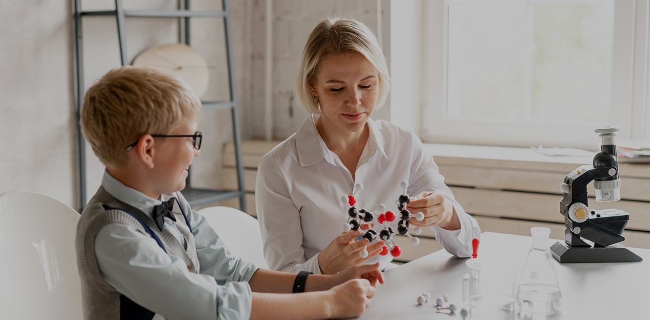 Female science tutor in Bronx studying chemistry with student